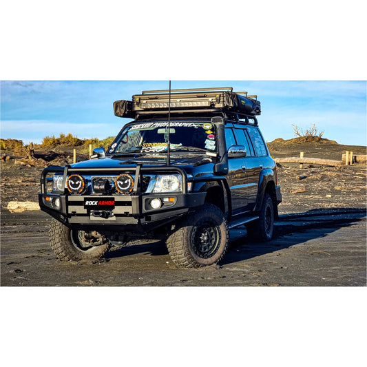 Black off-road vehicle with roof rack showcasing Rockarmor premium steel bullbar with fog lights