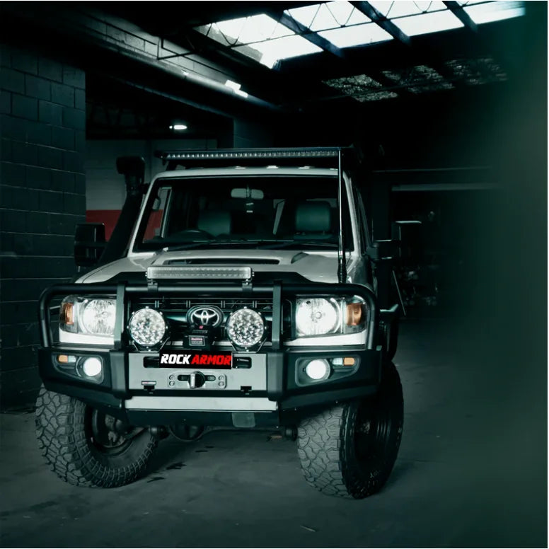Silver off-road vehicle with Rockarmor premium steel bullbar and fog lights