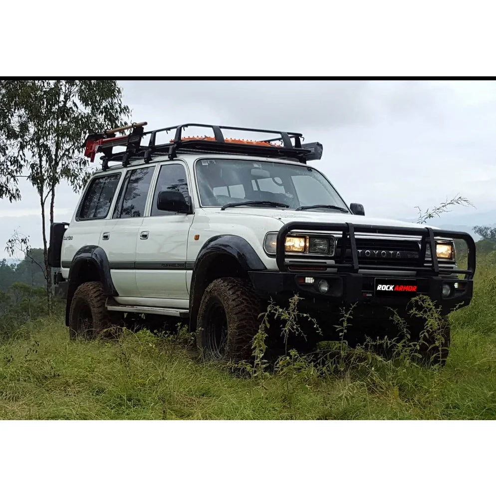 White Toyota Land Cruiser with steel bull bar and fog lights for off-road protection