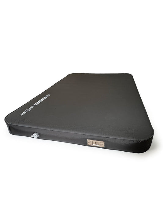 A black rectangular inflatable mattress with a visible air valve and a small label on one side, set against a plain white background.