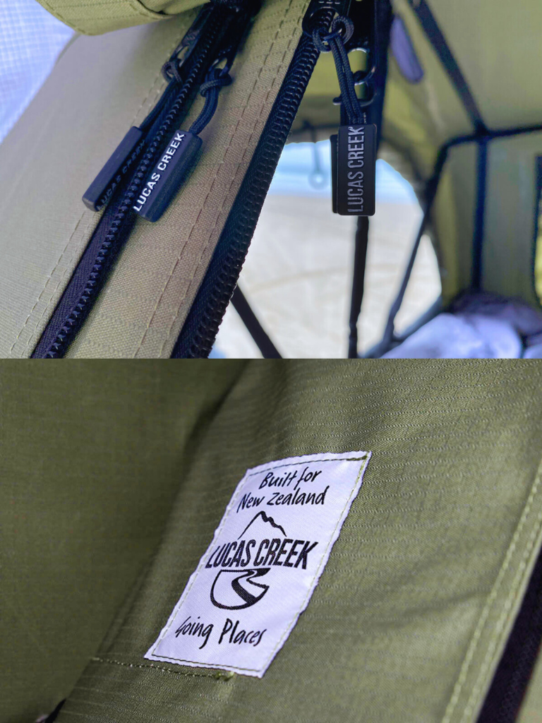 A Lucas Creek soft shell roof top tent showing zip pullers and logo. 