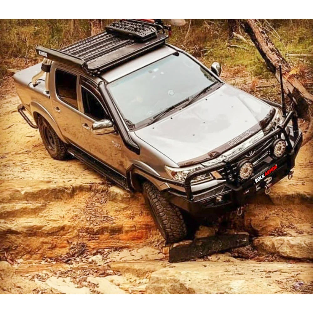Silver off-road pickup truck featuring steel checker plate Rockslider side steps with fitting video