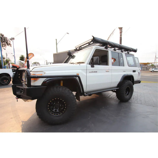 White off-road vehicle with roof rack and steel checker plate Rockslider Side Steps